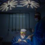 a group of doctors in scrubs in a dark room