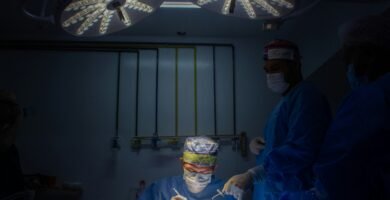 a group of doctors in scrubs in a dark room